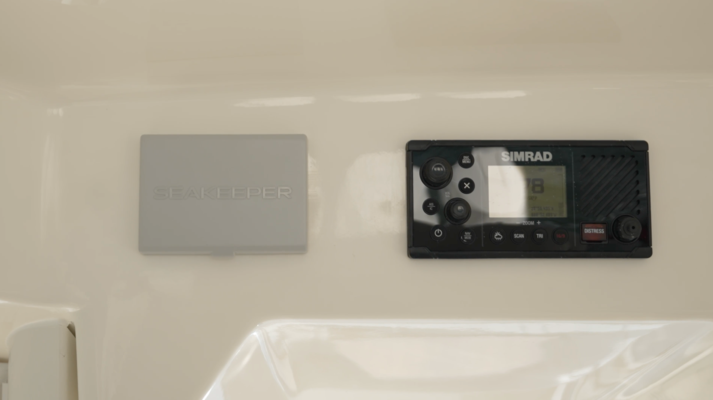 Boston Whaler 350 Realm The controls for the Simrad VHS and Seakeeper 3 gyro are located up above the helm console.